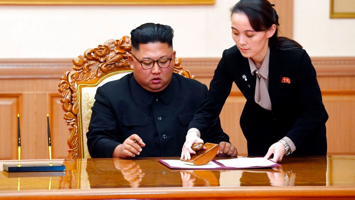 FILE: Kim Yo Jong, right, helps her brother North Korean leader Kim Jong Un sign a joint statement following the summit with South Korean President Moon Jae-in at the Paekhwawon State Guesthouse in Pyongyang, North Korea.