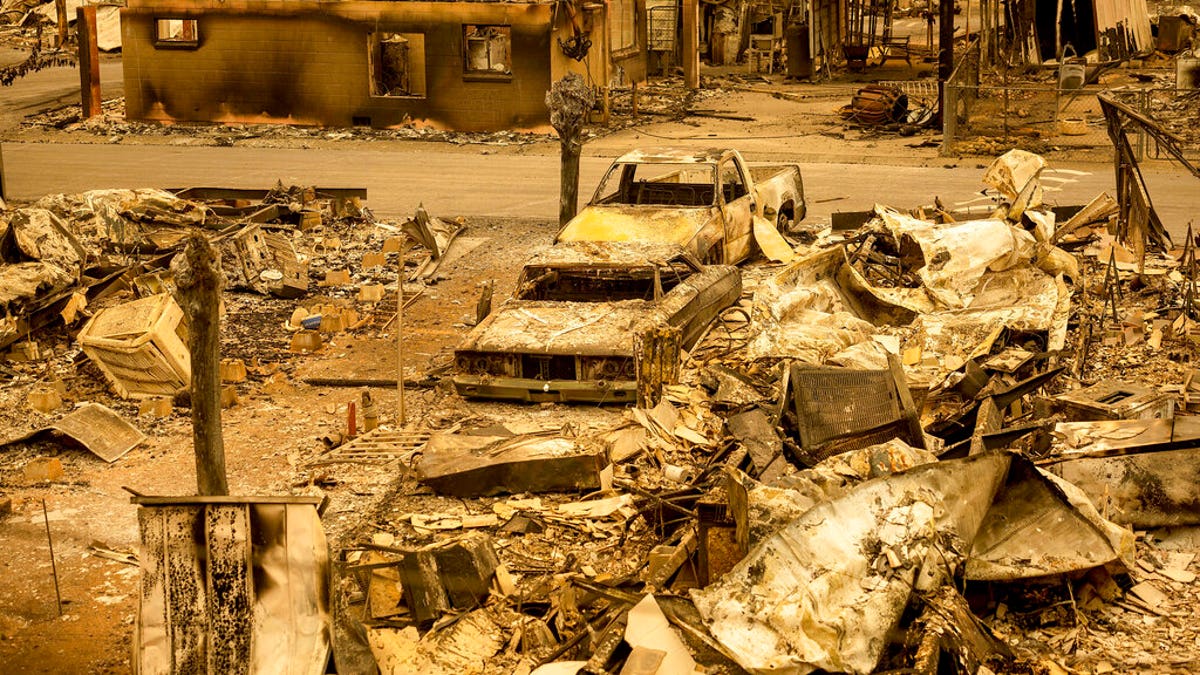 Scorched homes and vehicles fill Spanish Flat Mobile Villa following the LNU Lightning Complex fires in unincorporated Napa County, Calif., on Aug. 20. The fire destroyed dozens of homes at the mobile home park with only a handful that remained standing. Fire crews across the region scrambled to contain dozens of wildfires sparked by lightning strikes. (AP Photo/Noah Berger)