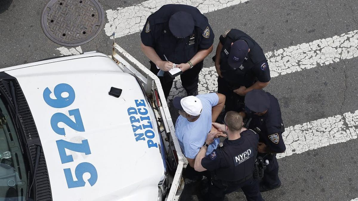 New York City police officers detain and question a man in the Bronx borough of New York. (AP Photo/Mark Lennihan, File)