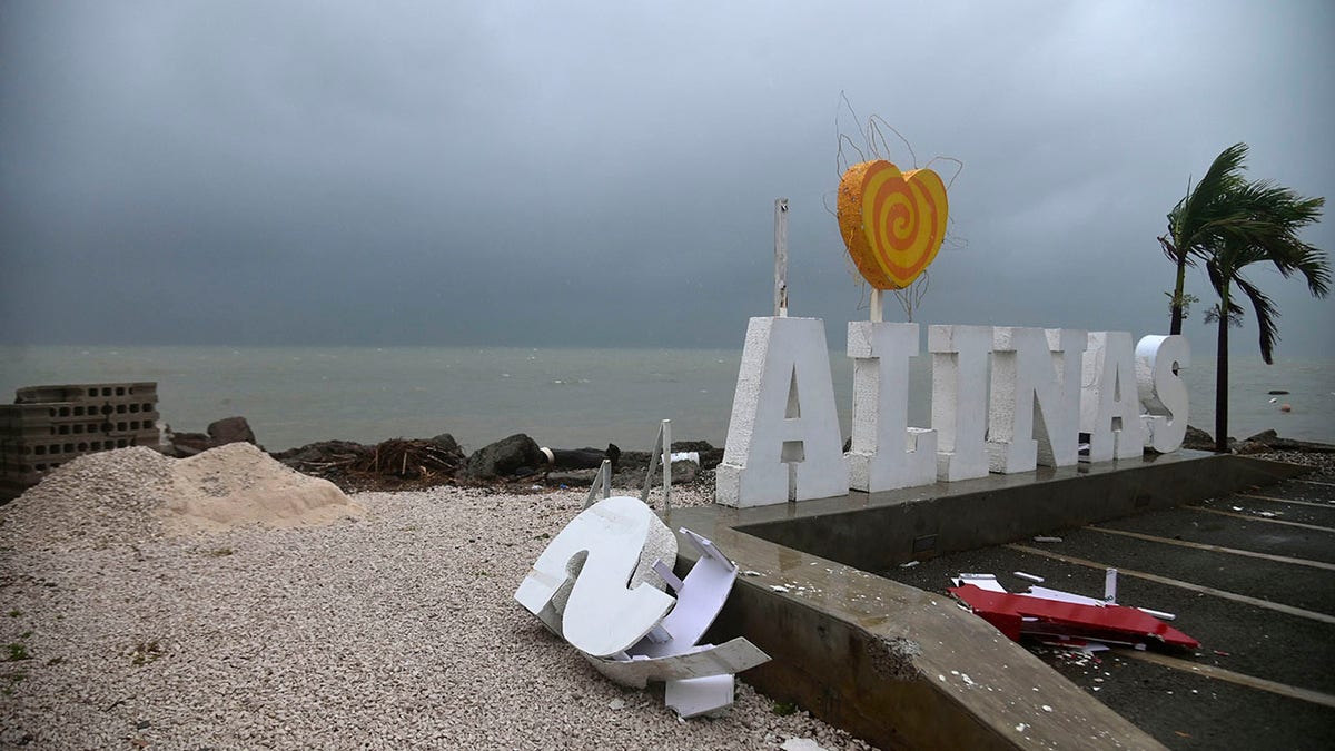 Remnants of a city sign lay on the beach damaged by Tropical Storm Laura in Salinas, Puerto Rico, Saturday, Aug. 22, 2020. Laura began flinging rain across Puerto Rico and the Virgin Islands on Saturday morning and was expected to drench the Dominican Republic, Haiti and parts of Cuba during the day on its westward course.