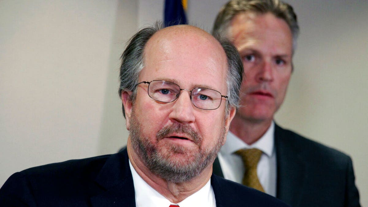 In this Sept. 26, 2019, file photo, Alaska Attorney General Kevin Clarkson, left, addresses reporters as Gov. Mike Dunleavy, right, looks on in Anchorage, Alaska.  (AP Photo/Mark Thiessen, File)