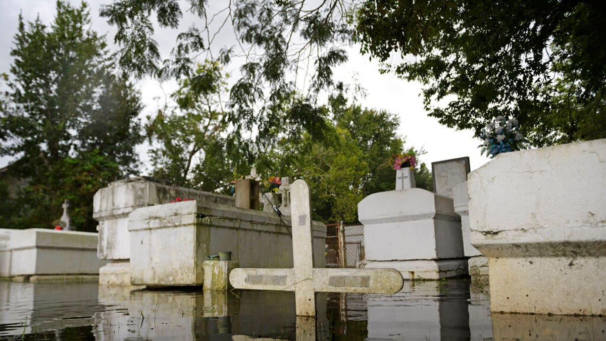 A cemetery along Privateer Blvd. in Barataria, La. is inundated in water as water levels surge before Hurricane Laura, Aug. 26, in Barataria, La. (Max Becherer/The Advocate via AP)