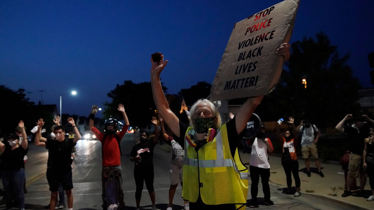 People gather to protest Wednesday, Aug. 26, 2020, in Kenosha, Wis. (AP Photo/Morry Gash)