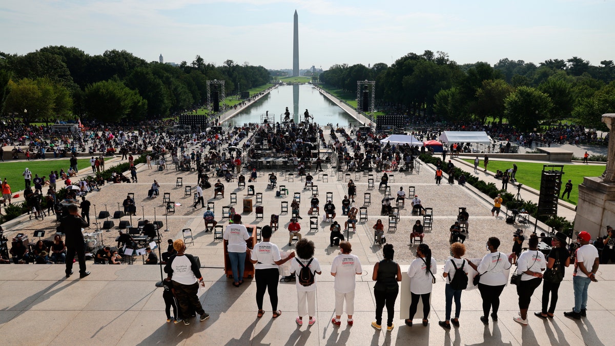 Demonstrators gather at the Lincoln Memorial as final preparations are made for the March on Washington, Friday Aug. 28, 2020, at the Lincoln Memorial in Washington, on the 57th anniversary of the Rev. Martin Luther King Jr.’s “I Have A Dream” speech. (Olivier Douliery/Pool via AP)