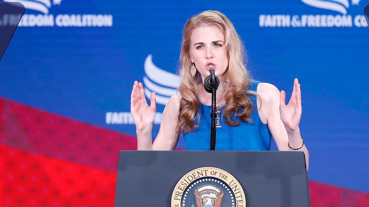 President Donald Trump, left, listens Natalie Harp, right, speak after inviting her on stage at the Faith &amp; Freedom Coalition conference in Washington, Wednesday, June 26, 2019. (AP Photo/Pablo Martinez Monsivais)