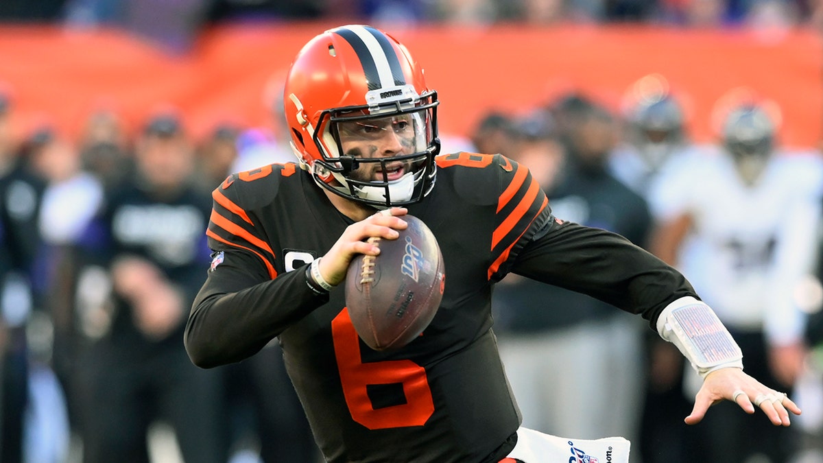In this Dec. 22, 2019, file photo, Cleveland Browns quarterback Baker Mayfield scrambles during the second half of an NFL football game against the Baltimore Ravens in Cleveland.(AP Photo/David Richard, File)