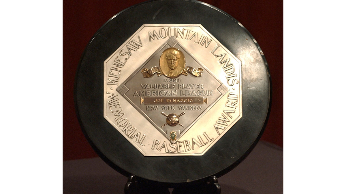 In this Jan. 22, 2006, file photo, a Joe DiMaggio 1947 MVP Award plaque is displayed at a news conference in New York. The plaque features the name and image of Kenesaw Mountain Landis. (AP Photo/Jennifer Szymaszek, File)