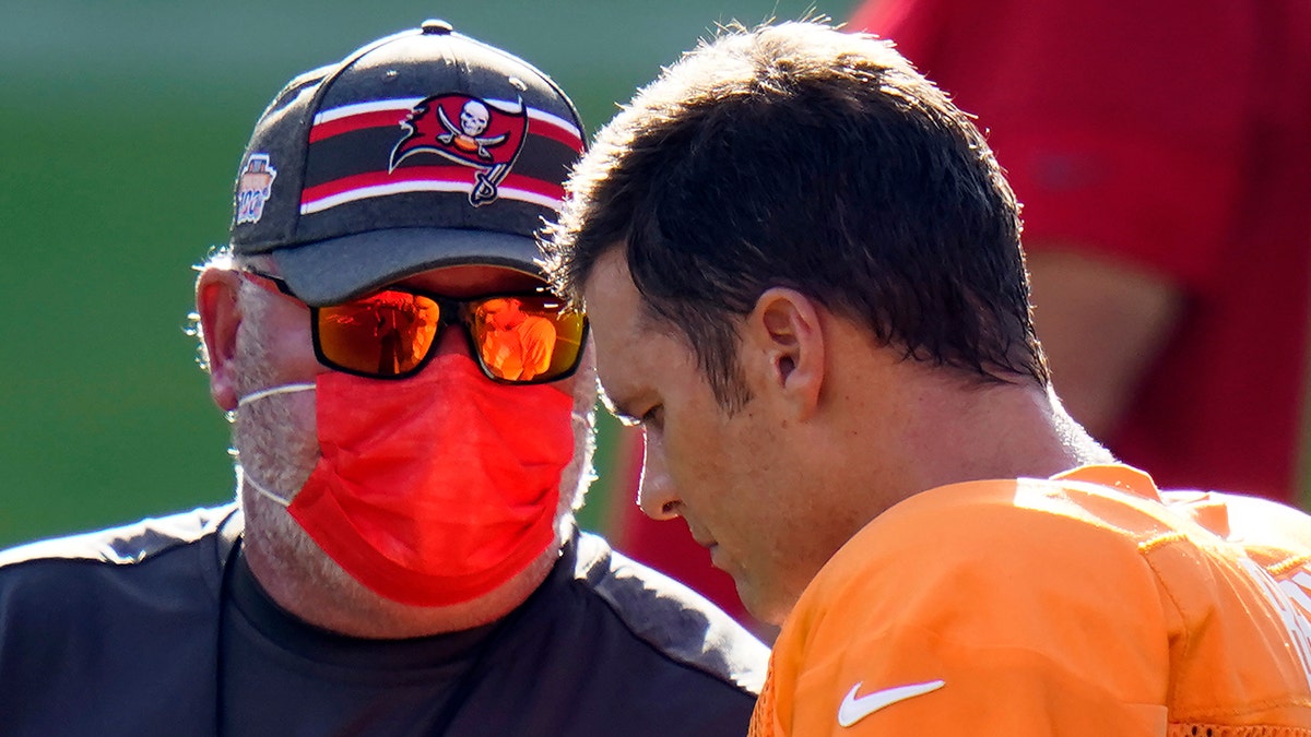 Tampa Bay Buccaneers head coach Bruce Arians talks to quarterback Tom Brady (12) during an NFL football training camp practice Friday, Aug. 28, 2020, in Tampa, Fla. (AP Photo/Chris O'Meara)