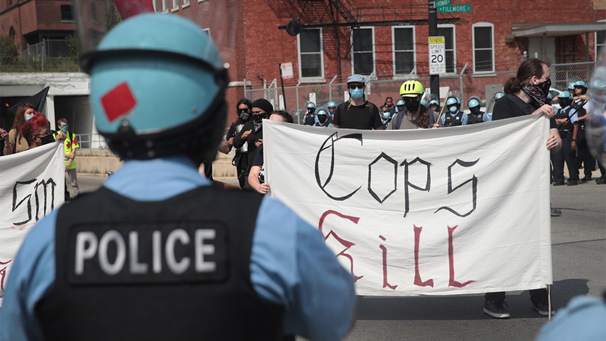Police stand guard as pro and anti-police demonstrators gather outside of the Homan Square police station on August 15, 2020 in Chicago, Illinois. (Photo by Scott Olson/Getty Images)