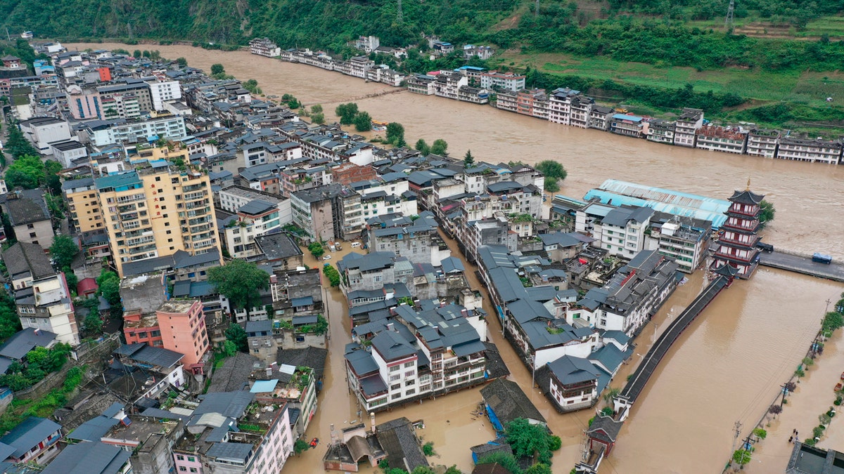 In this aerial photo released by China's Xinhua News Agency, flooding is seen in Bikou township of Longnan city in northwestern China's Gansu Province, Tuesday, Aug. 18, 2020.