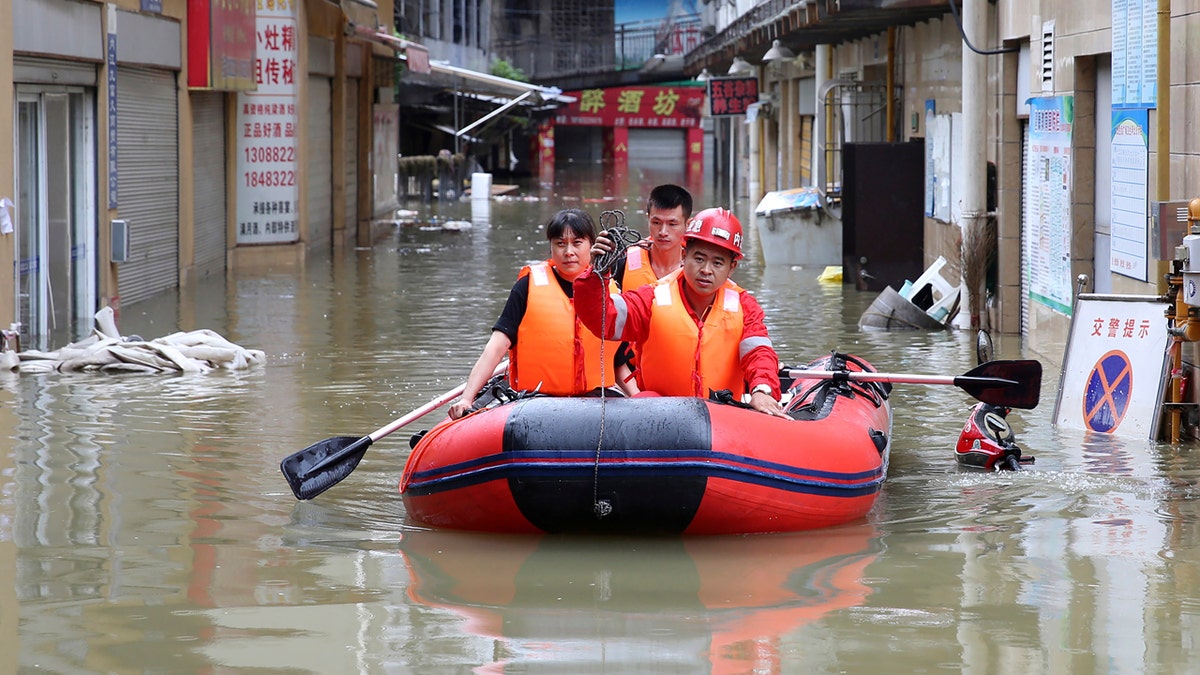 Heavy rains, floods in China strand dozens on rooftops, triggering ...