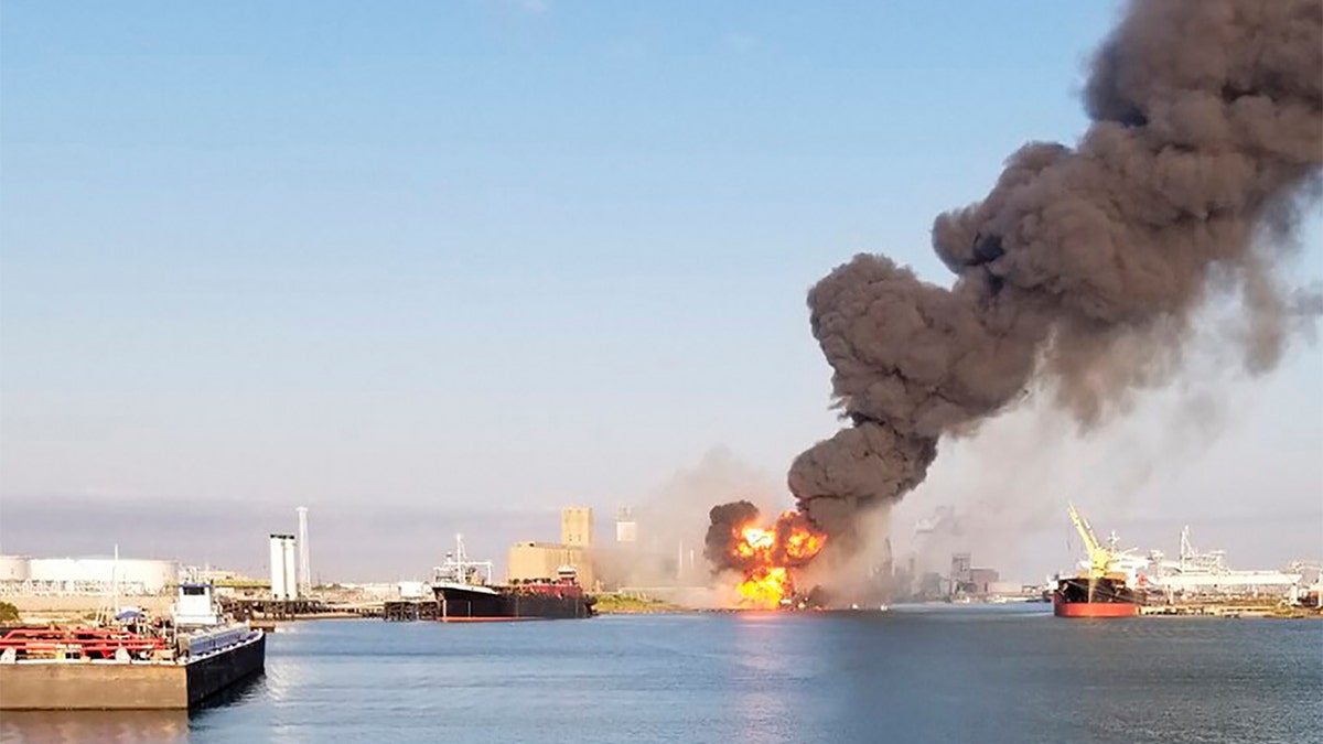In this photo released by the U.S. Coast Guard, Coast Guard crews respond to a dredge on fire in the Port of Corpus Christi Ship Channel, Aug. 21, in Corpus Christi, Texas. Authorities say several people have been hospitalized after an explosion at the Texas port when a dredging vessel hit a natural gas pipeline in the water. (U.S. Coast Guard via AP)