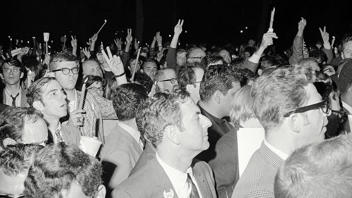 Part of a large group of Democratic convention delegates and alternates who were disappointed by the nomination of Hubert Humphrey for president march holding candles along Michigan Avenue early on Aug. 29, 1968, in silent protest. (AP Photo)