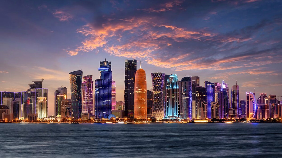 The illuminated, urban skyline of Doha, Qatar, with the modern skyscrapers just after sunset