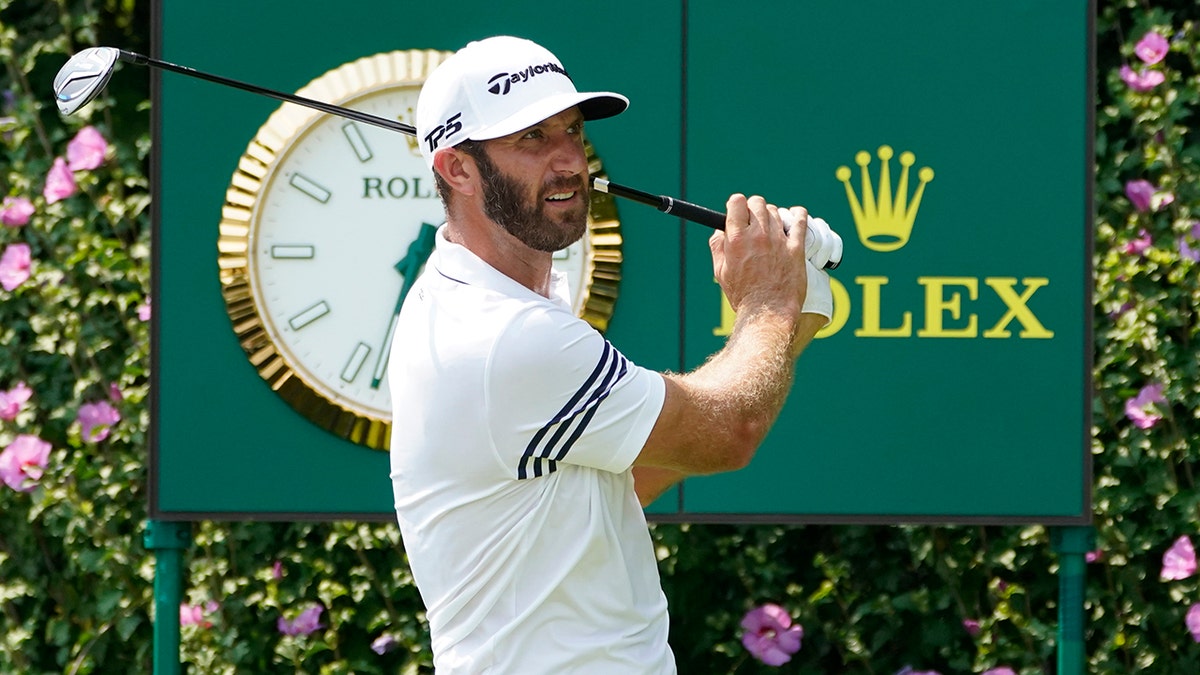 Dustin Johnson watches his tee shot during a practice round Wednesday, Aug. 26, 2020, for the BMW Championship golf tournament at the Olympia Fields Country Club in Olympia Fields, Ill. (AP Photo/Charles Rex Arbogast)