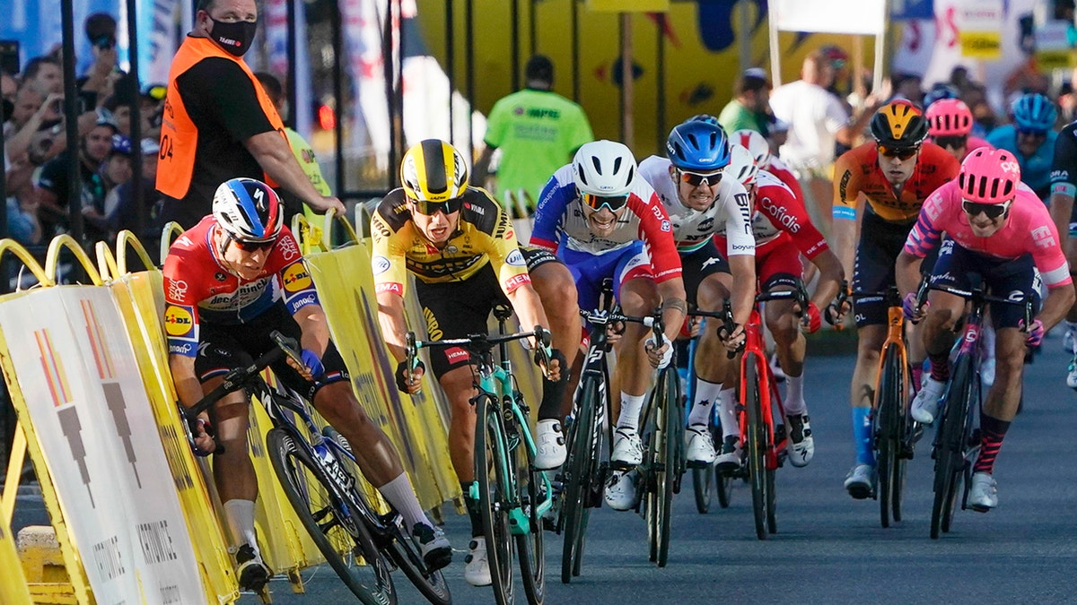 Sprinting for the win Dutch cyclist Fabio Jakobsen, left, hits side barriers at the start of a crash with his countryman Dylan Groenewegen, 2nd left, on the final stretch of the opening stage of the Tour de Pologne race in Katowice, Poland, on Wednesday, Aug. 5, 2020. (AP Photo/Tomasz Markowski)<br>