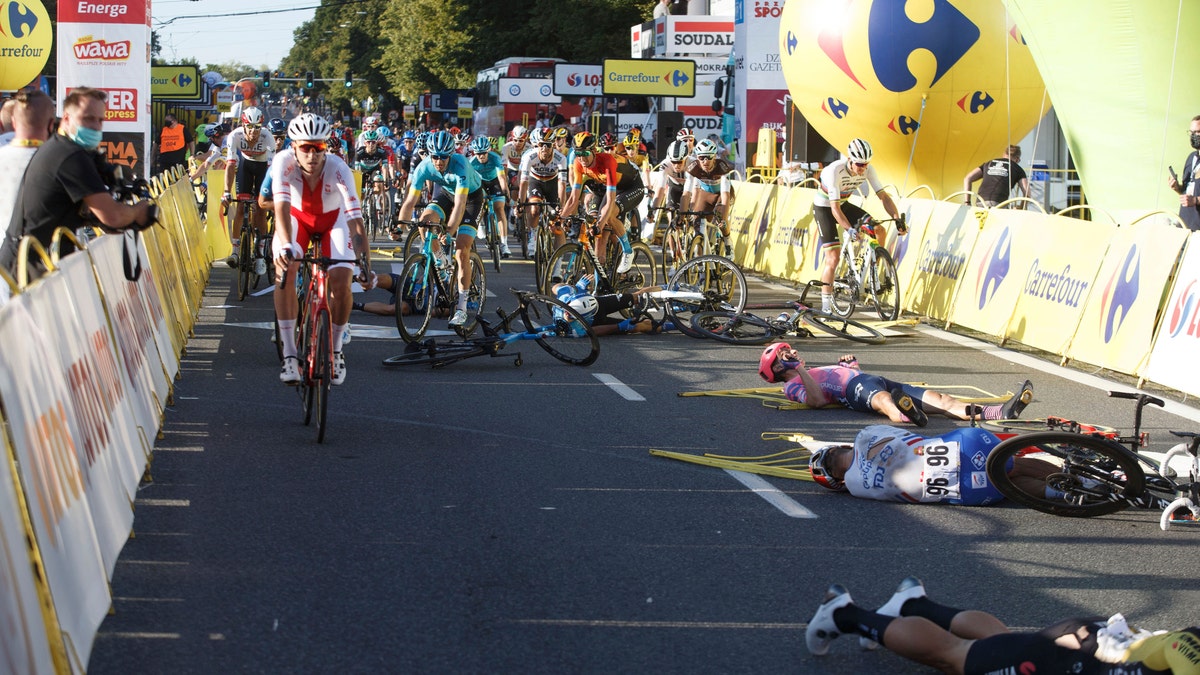 Cyclists are injured in a crash on the final stretch of the opening stage of the Tour de Pologne race in Katowice, Poland, on Wednesday, Aug. 5, 2020. (AP Photo)<br>