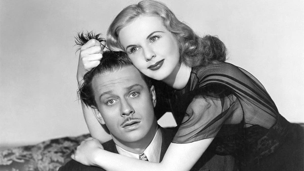 Actress Deanna Durbin and David Bruce in a scene from the movie 'Lady on a Train.'