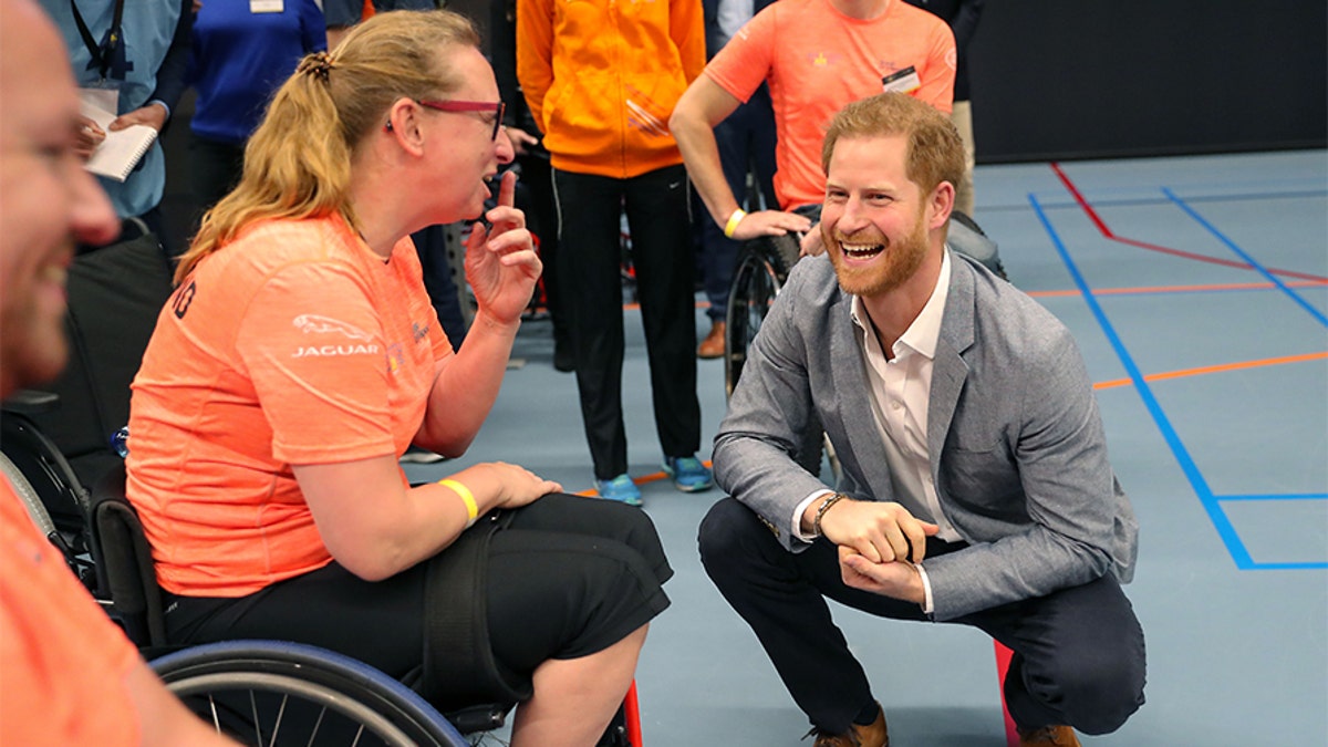 Prince Harry, Duke of Sussex speaks with athletes during a sports training session at Sportcampus Zuiderpark during a visit to The Hague as part of a program of events to mark the official launch of the Invictus Games.