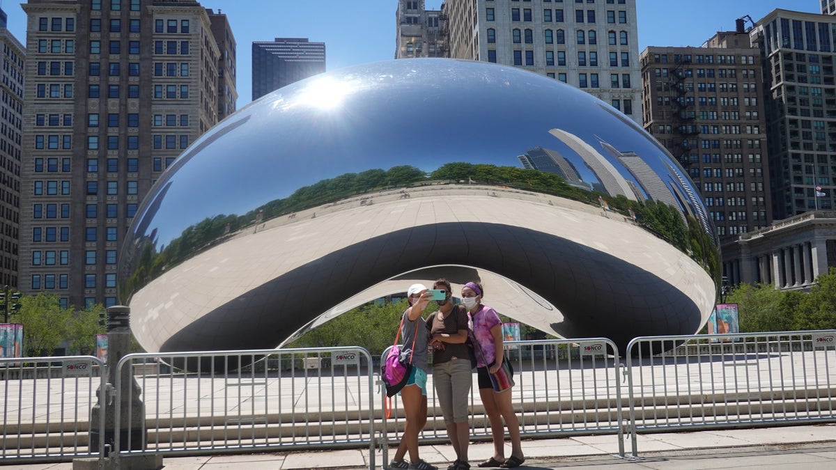 Visitors take pictures in front of the Cloud Gate sculpture in Millennium Park on June 15 in Chicago, Illinois. (Scott Olson/Getty Images)