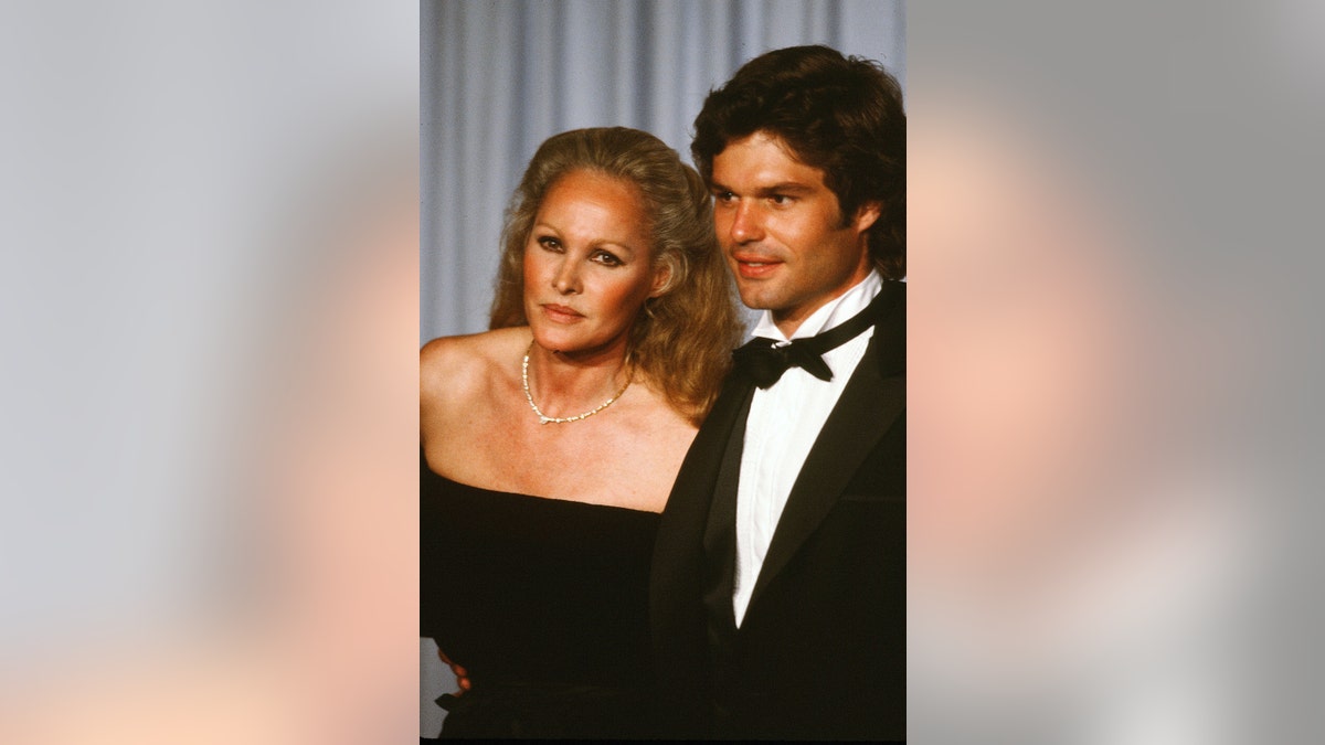 Actress Ursula Andress with actor Harry Hamlin poses backstage during the 54th Academy Awards at Dorothy Chandler Pavilion in Los Angeles, Calif.