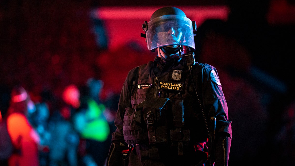 Portland police are seen in riot gear during a standoff with protesters in Portland, Oregon on August 16, 2020. Protests have continued for the 80th consecutive night in Portland since the killing of George Floyd. (Photo by Paula Bronstein/Getty Images)
