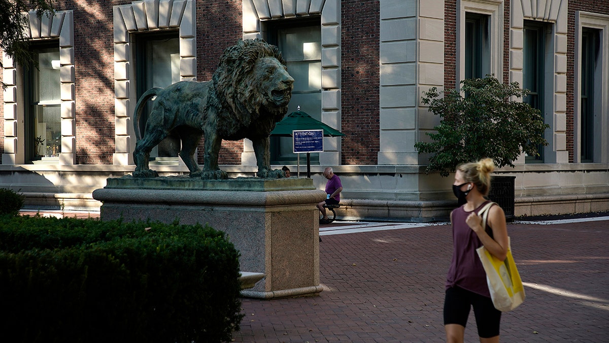 Woman wearing a protective mask walks on the campus of Columbia University on Aug. 23, 2020 in New York City. (Photo by John Lamparski/Getty Images)