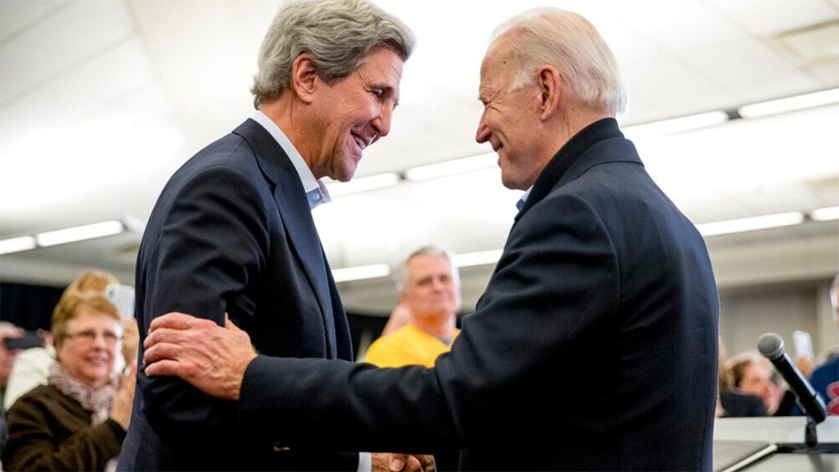 Democratic presidential candidate former Vice President Joe Biden smiles as former Secretary of State John Kerry, left, takes the podium to speak at a campaign stop at the South Slope Community Center, Saturday, Feb. 1, 2020, in North Liberty, Iowa. (AP Photo/Andrew Harnik)