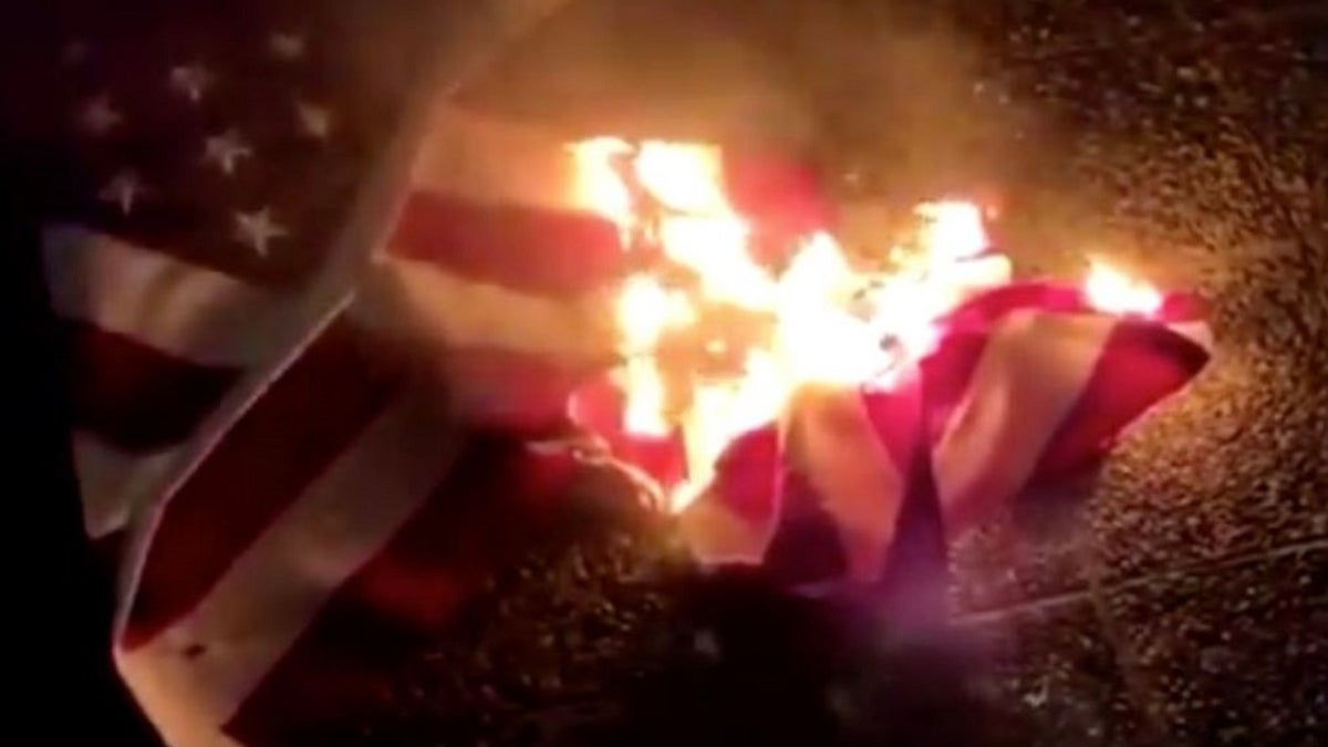 Protesters vandalized a Los Angeles Police Department station Friday, spray-painting anti-police slogans and burning an American flag, authorities said. 