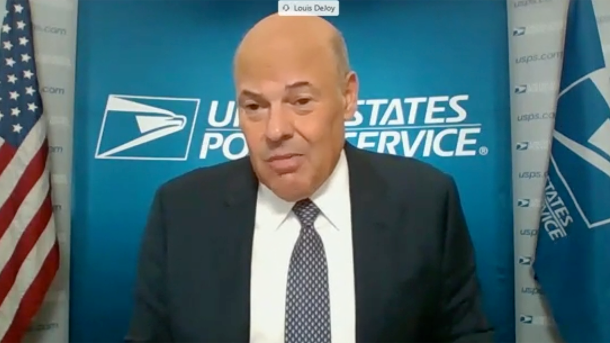 Postmaster General Louis DeJoy testifies in a Senate hearing Friday amid controversy over whether USPS will be able to deliver mail-in ballots on time for the Nov. 3 election. DeJoy assured committee members that he is committed to making that happen and that USPS has the resources to do so.