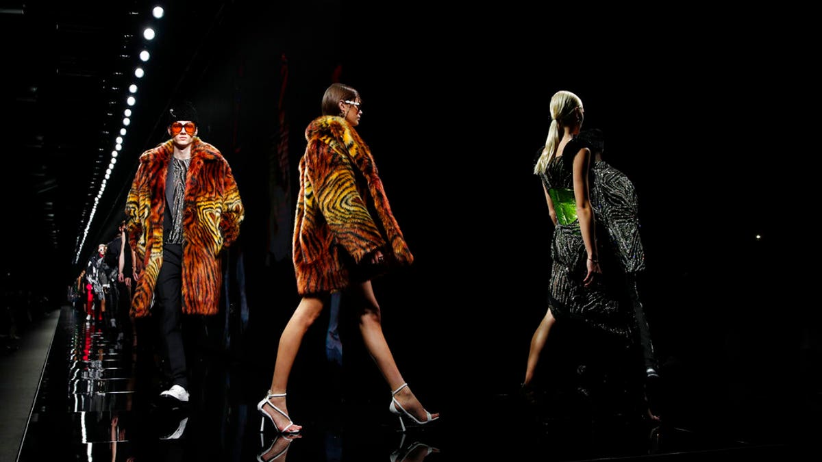 In this Friday, Feb. 21, 2020 file photo, models wear creations as part of Versace Fall/Winter 2020/2021 collection, presented in Milan, Italy.