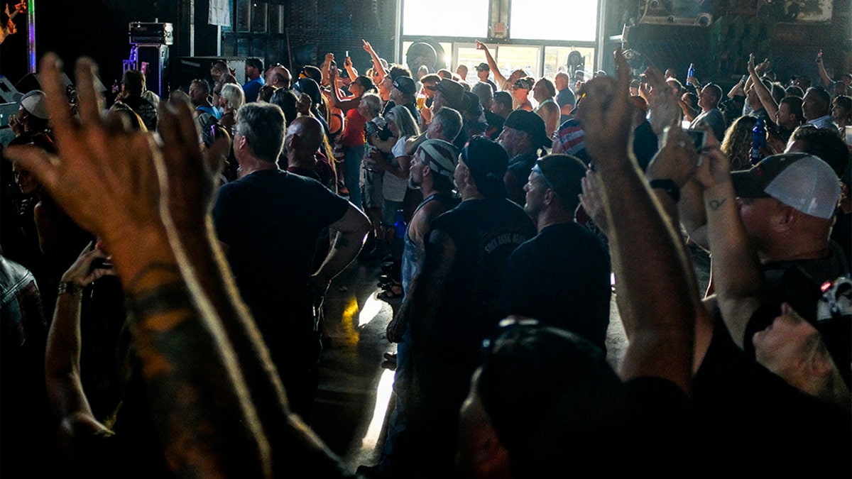 People cheer during a concert at the Full Throttle Saloon during the 80th Annual Sturgis Motorcycle Rally on August 7, 2020 in Sturgis, South Dakota. While the rally usually attracts around 500,000 people, officials estimate that more than 250,000 people may still show up to this year's festival despite the coronavirus pandemic.