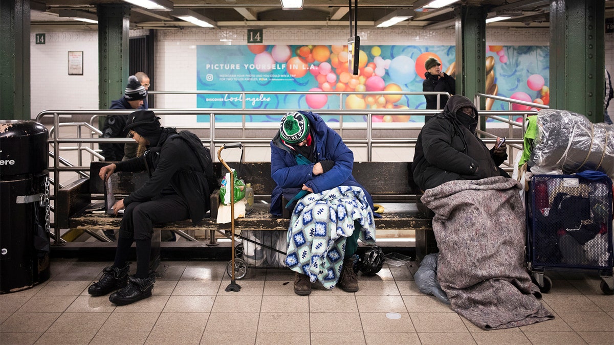 New York City, NY - March 22, 2017: Unidentified New York homeless people sleeping in the subway station in Manhattan, New York City