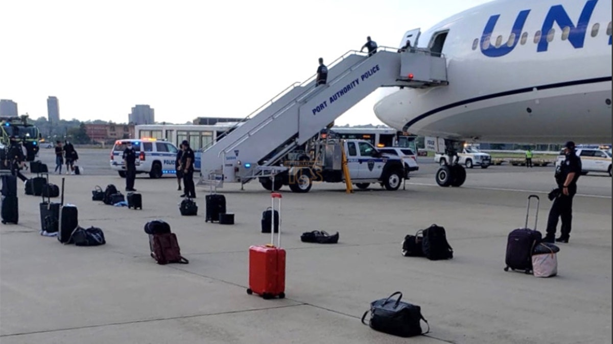 Police and K-9 were brought in to go through passenger luggage for potential explosives. After clearing the luggage, passengers were reportedly bused to a terminal. (Courtesy Lakewood Scoop)