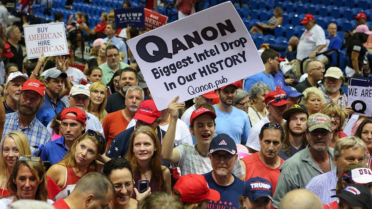 Trump supporters displaying QAnon posters appeared at President Donald J. Trumps Make America Great Again rally Tuesday, July 31, 2018 at the Florida State Fair Grounds in Tampa Florida.  (Photo by Thomas O'Neill/NurPhoto via Getty Images)