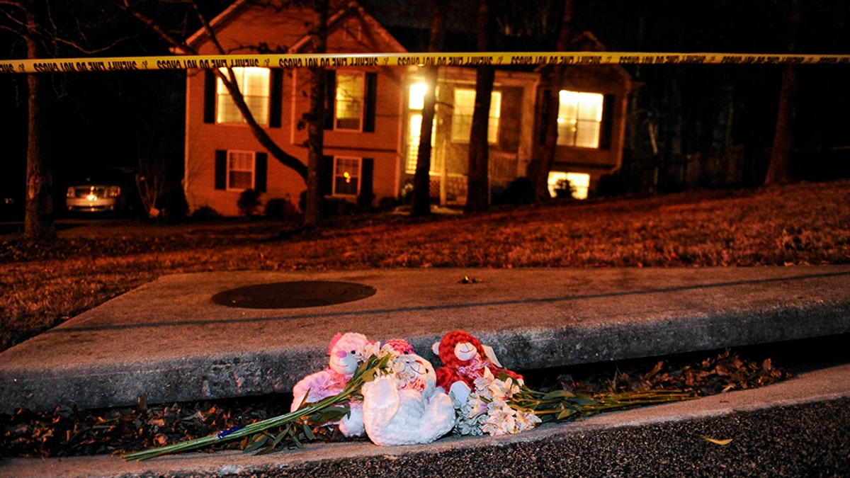 A makeshift memorial is shown outside a home in a suburban neighborhood in Douglasville, Georgia, February 7, 2015. At least seven people were shot in the community west of Atlanta on Saturday in an attack that left five people dead, local media reports. REUTERS/John Amis (UNITED STATES - Tags: CRIME LAW) - TM3EB271MGP01