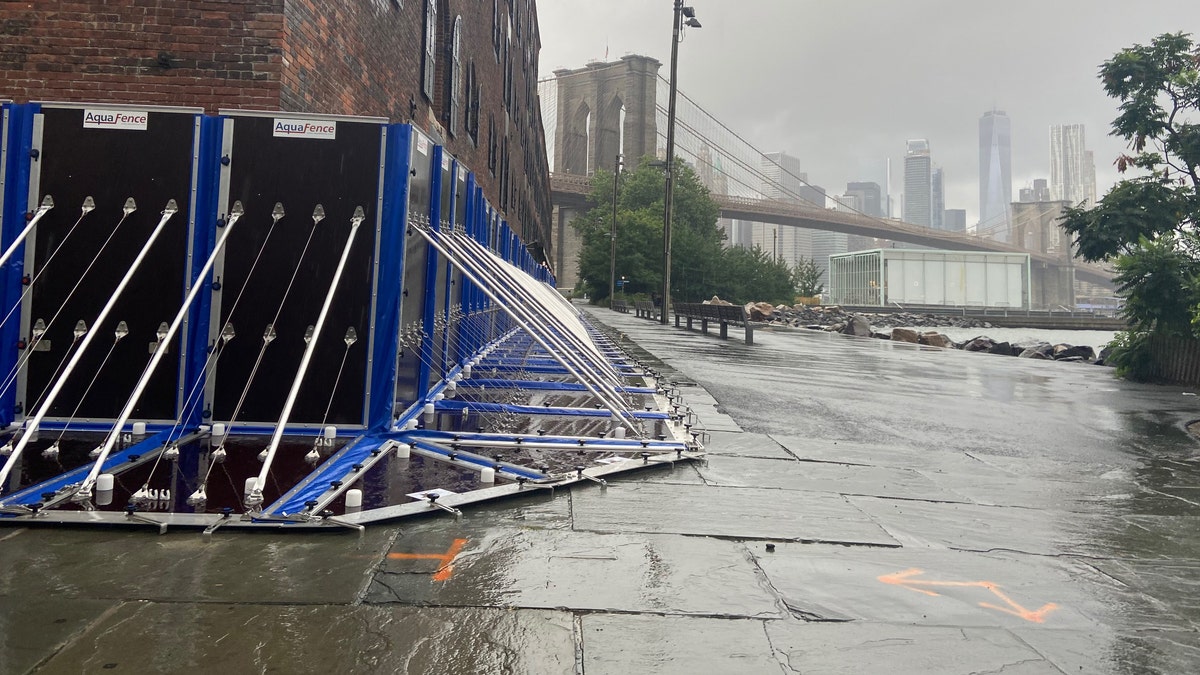 The flood barrier around the Empire Stores complex with the Brooklyn Bridge and Jane's Carousel in the background.