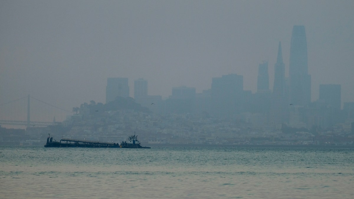 The San Francisco skyline is barely visible through smoke from wildfires Wednesday, Aug. 19, 2020, in this view from Sausalito, Calif.