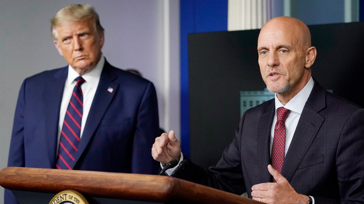 President Trump listens as the FDA's Stephen Hahn speaks to the media in the James Brady Briefing Room of the White House, Sunday, Aug. 23, 2020, in Washington. (AP Photo/Alex Brandon)