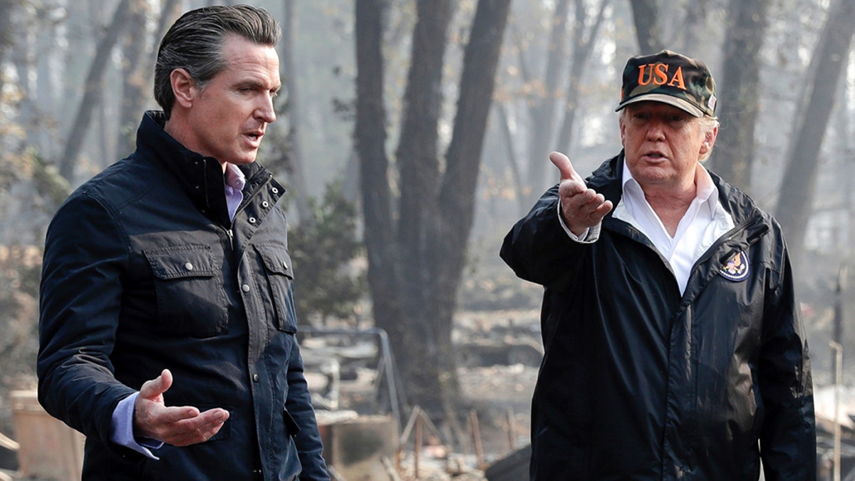 In this Nov. 17, 2018 photo, President Trump talks with then Gov.-elect Gavin Newsom, left, during a visit to a neighborhood impacted by the wildfires in Paradise, Calif. (AP Photo/Evan Vucci, File)