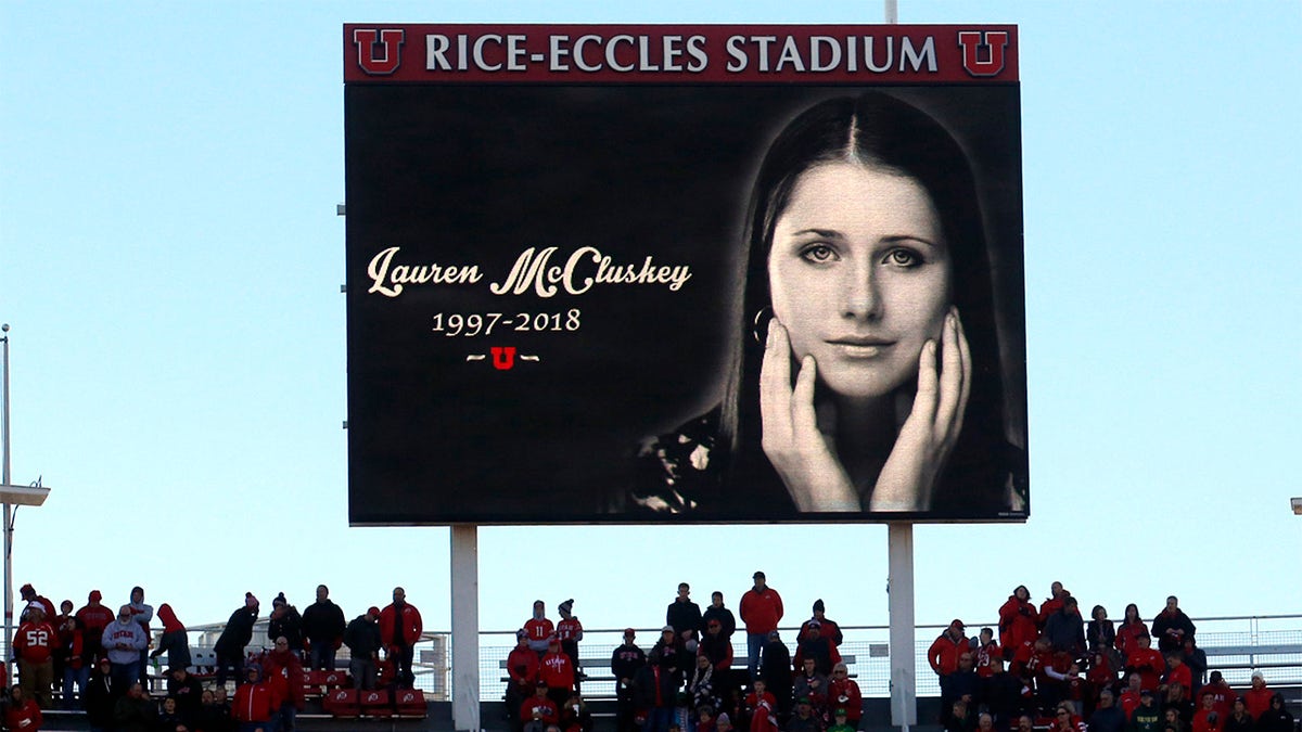 In this Nov. 10, 2018, photo, a photograph of University of Utah student and track athlete Lauren McCluskey, who was fatally shot on campus, is projected on the video board before the start of an NCAA college football game between Oregon and Utah in Salt Lake City. (AP Photo/Rick Bowmer, File)