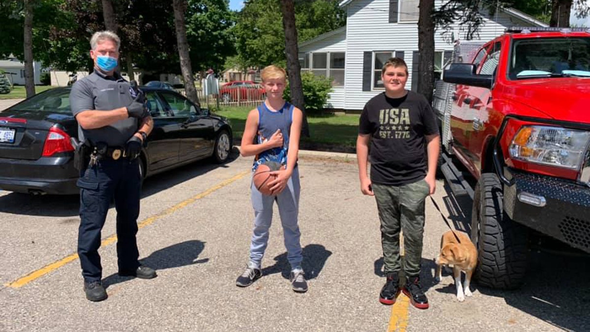 The Wayland Police Department made Austin Nichols, 13, and Logan Mishoe, 14, holding dog, honorary "Citizens of the Day" after finding a cash-filled wallet in a park and turning it in to an officer. 