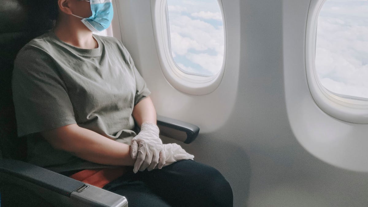 passenger wearing mask on plane