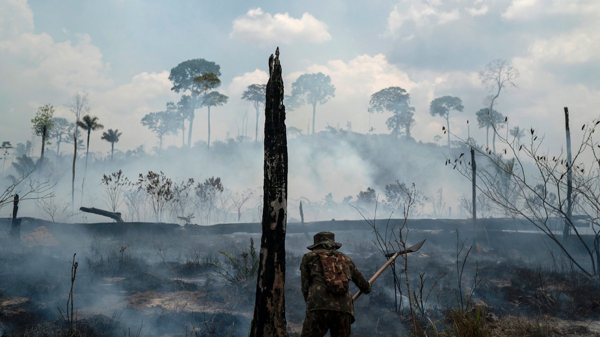 In this Sept. 3, 2019, file photo, Brazilian soldier puts out fires at the Nova Fronteira region in Novo Progresso, Brazil.