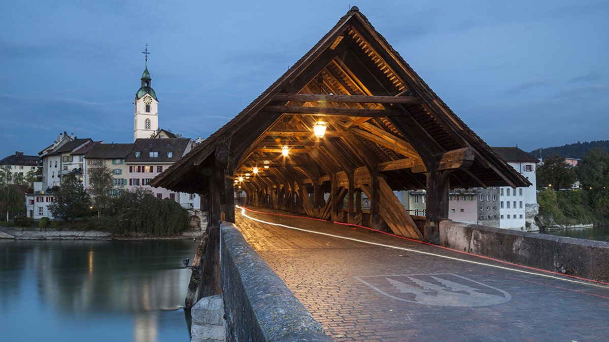Covered bridge over Aare river in Olten at dawn. (Photo by: Loop Images/Universal Images Group via Getty Images)