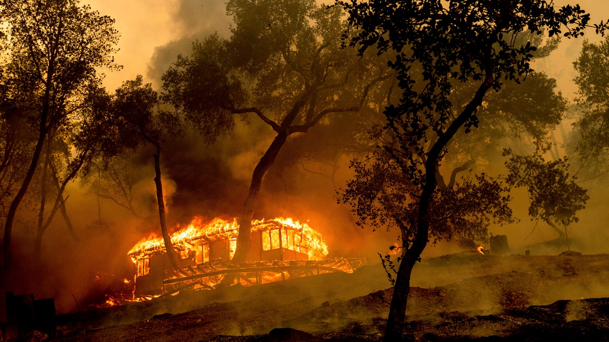 Flames consume a cabin at the Nichelini Family Winery in unincorporated Napa County as the Hennessey Fire burns on Tuesday, Aug. 18, 2020.