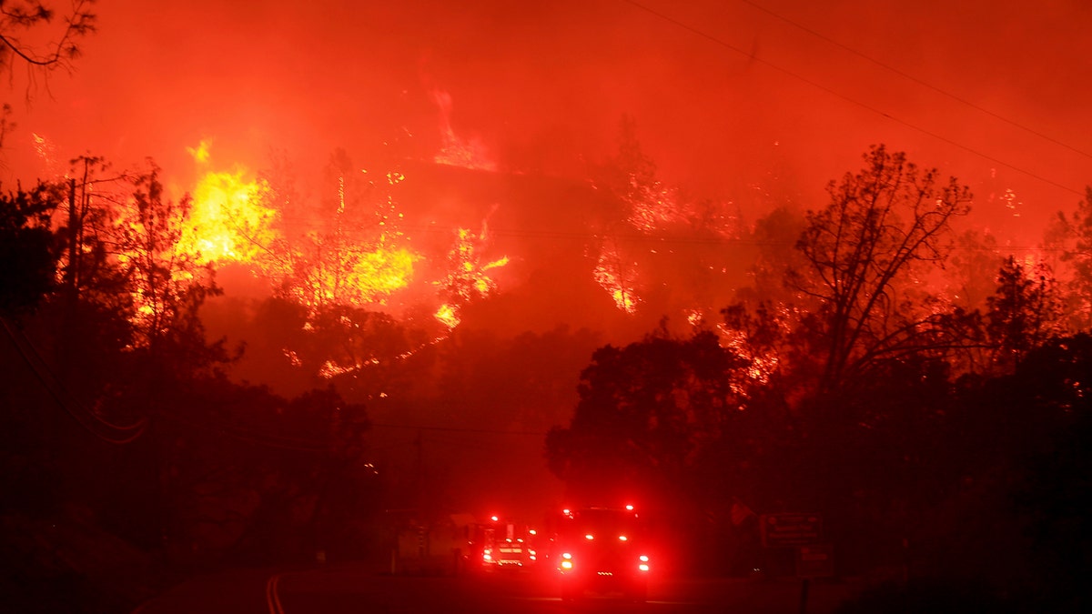 A wildfire also known as the Hennessey Fire crosses Knoxville Berryessa Road, west of Sacramento, Calif., Tuesday, Aug. 18, 2020.