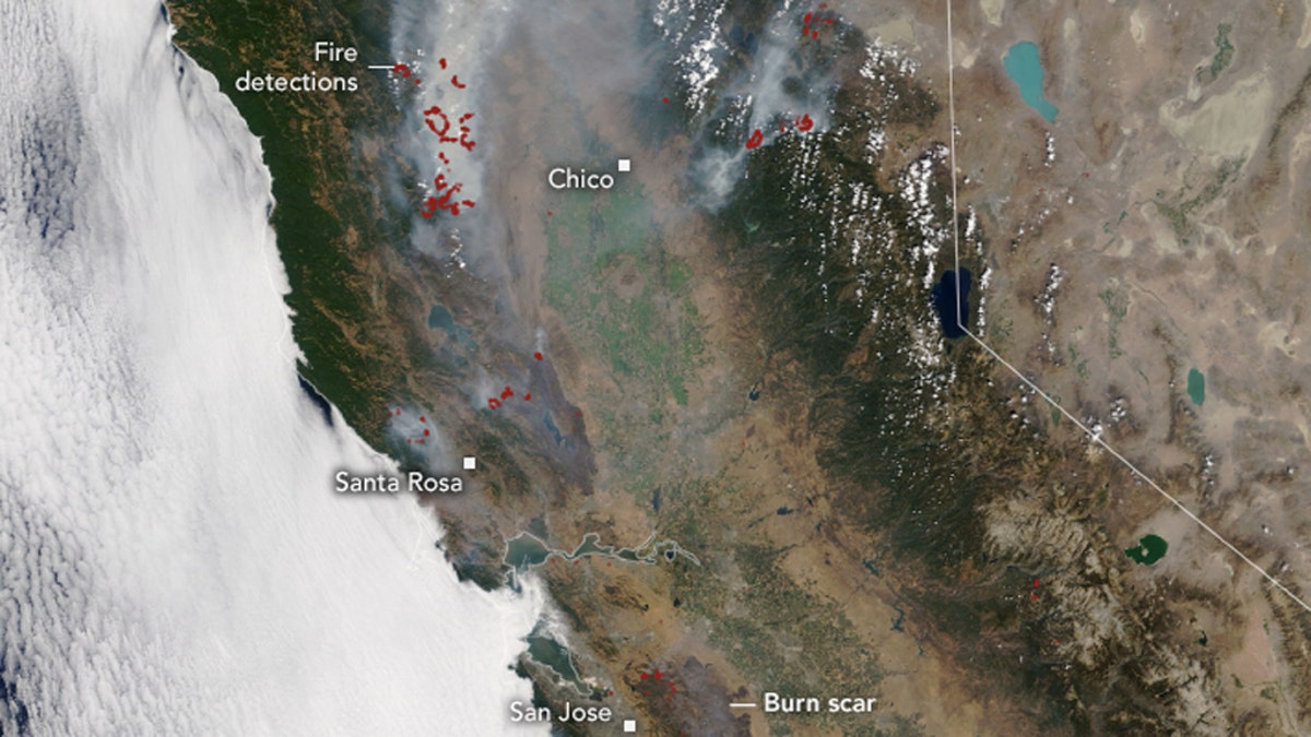 Burn scars can be seen on satellite imagery from NASA, as well as where active fires are burning in Northern California on Aug. 26, 2020.