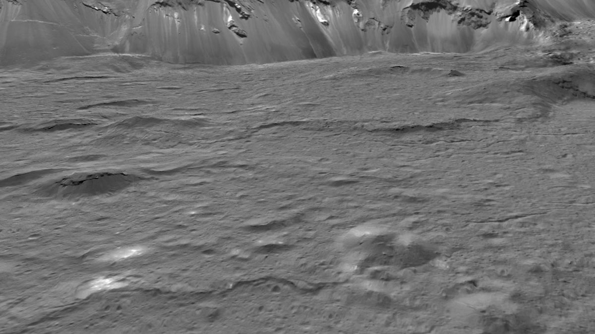 This mosaic of Ceres' Occator Crater is composed of images NASA's Dawn mission captured on its second extended mission, in 2018. Bright pits and mounds (foreground) were formed by salty liquid released as Occator's water-rich floor froze after the crater-forming impact about 20 million years ago. (NASA/JPL-Caltech/UCLA/MPS/DLR/IDA/USRA/LPI)