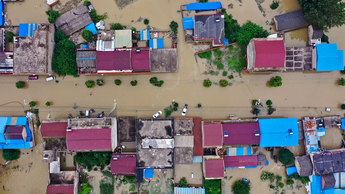 In this July 20, 2020, aerial file photo released by Xinhua News Agency shows the extent of flooding in Guzhen Town of Lu'an City in eastern China's Anhui Province.